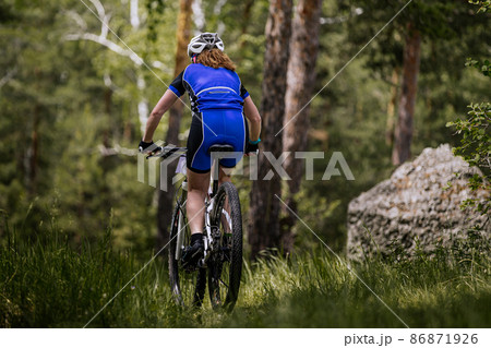back woman biking mountain bike on trail forest back woman biking mountain bike on trail forest 86871926