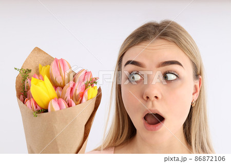 Excited girl with bouquet of flowers on white background Excited girl with bouquet of flowers on white background 86872106