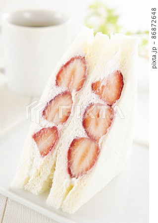 ホイップクリームたっぷりの苺サンドイッチとホットコーヒー 86872648