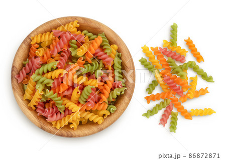 raw Fusilli colored pasta in wooden bowl isolated on white background with clipping path and full depth of field. Top view. Flat lay 86872871