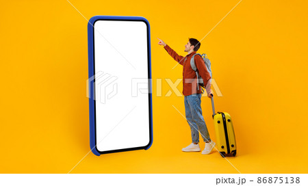 Tourist Guy Using Huge Cellphone With Empty Screen, Yellow Background 86875138