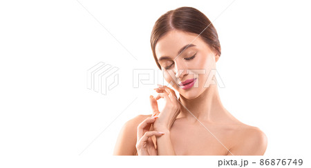 Photo on white backgroung - portrait of a 30 years old woman with closed eyes touching her skin. Photo on white backgroung - portrait of a 30 years old woman with closed eyes touching her skin. 86876749
