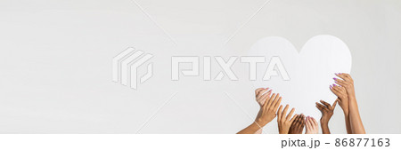 In the panoramic frame, there is a large white heart supported by eight colored hands from different nations and races. Many races but a common pure heart. In the panoramic frame, there is a large white heart supported by eight colored hands from different nations and races. Many races but a common pure heart. 86877163