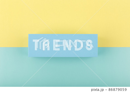 Trends written on rectangle on light multicolored yellow and aqua blue background 86879059