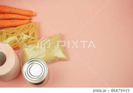 Food supply quarantine food crisis isolated on pink background. Rice, pasta, canned food, carrots, toilet paper. The concept of food delivery, donation, charity. Copyspace. 86879435