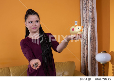 Reasonable planning and saving money are effective after the first year. A happy young teenager because she has learned to plan her expenses well. 86879635