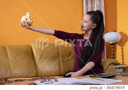 Reasonable planning and saving money are effective after the first year. A happy young teenager because she has learned to plan her expenses well. Reasonable planning and saving money are effective after the first year. A happy young teenager because she has learned to plan her expenses well. 86879654
