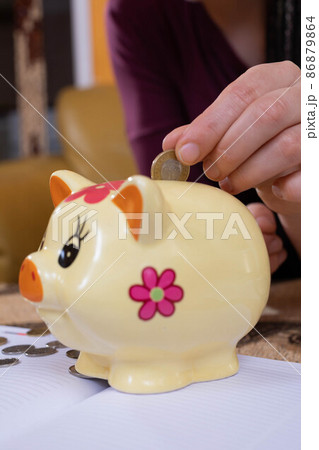 Teenagers were left with the last pennies of spending savings until the end of a long month. The girl holds a dime in her fingers, hoping for a better future Teenagers were left with the last pennies of spending savings until the end of a long month. The girl holds a dime in her fingers, hoping for a better future 86879864