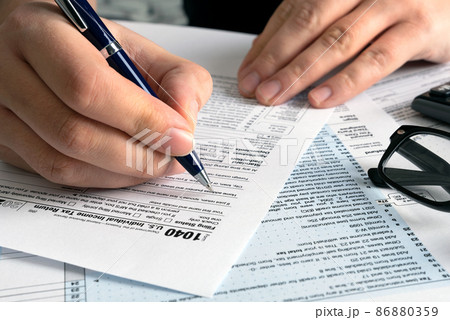 Tax return concept wits US 1040 tax form 86880359