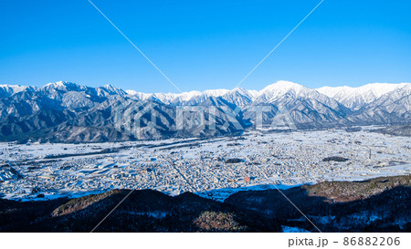 鷹狩山から望む冬の北アルプスと大町市の町並み 鷹狩山から望む冬の北アルプスと大町市の町並み 86882206