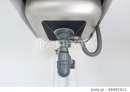 Drain pipe or sewer under kitchen sink in drainage system. Drain pipe or sewer under kitchen sink in drainage system. 86882811