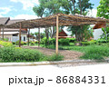 Wooden frame made of bamboo. Bamboo walkway arch. 86884331
