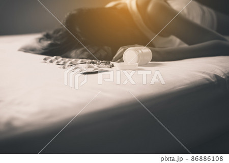 Drug pill and addict overdose concept,Woman sleep unconscious after eaten pills 86886108