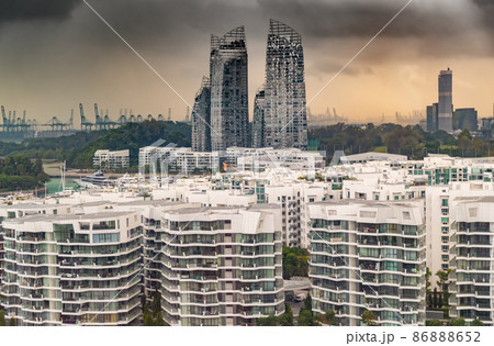 Top of real estate housing in down town of Singapore, few skyscrapers on background, storm sky at sunset Top of real estate housing in down town of Singapore, few skyscrapers on background, storm sky at sunset 86888652