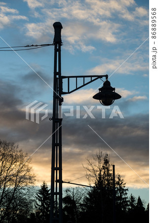 closeup of modern street lamp on sunset sky background closeup of modern street lamp on sunset sky background 86889568