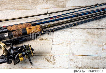 Fishing rod on the wooden flat lay table background with copy space. 86890894