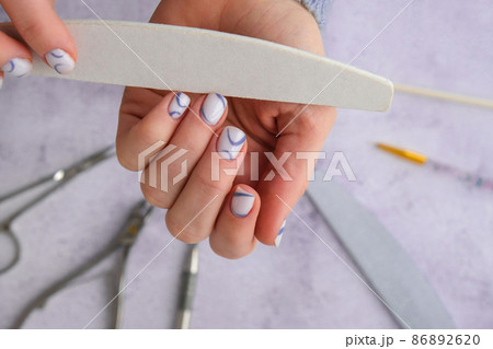 Professional stylish trendy blue Hardware Manicure. Procedure for the preparation of nails. Cuticle Pusher Remover. Nail file scissors Top view flat lay. Self care. Spa, beautician advertisement. Professional stylish trendy blue Hardware Manicure. Procedure for the preparation of nails. Cuticle Pusher Remover. Nail file scissors Top view flat lay. Self care. Spa, beautician advertisement. 86892620