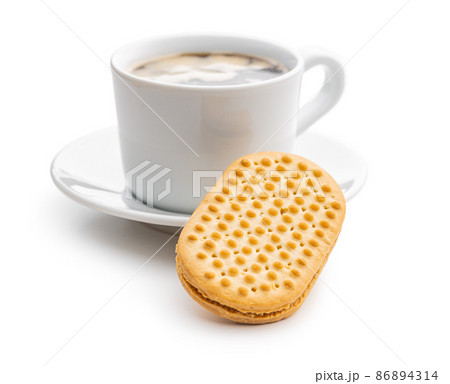 Sweet sandvich cookies and coffee cup. Biscuits with cocoa cream filling isolated on white background. Sweet sandvich cookies and coffee cup. Biscuits with cocoa cream filling isolated on white background. 86894314