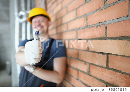 Foreman in helmet show thumbs up on construction site, handyman made good job Foreman in helmet show thumbs up on construction site, handyman made good job 86895816