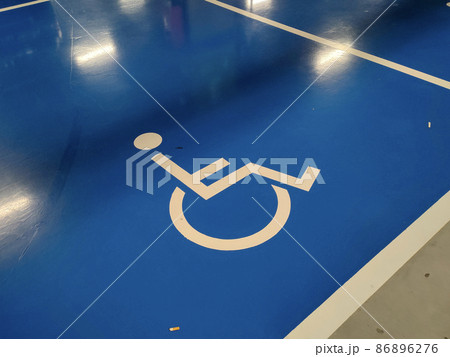 PENANG, MALAYSIA -OCTOBER 24, 2020: Parking for the disabled. The parking lot has a blue background and has a special logo. Also placed are pillared signage so that it is easy to see. 86896276