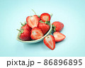 Top view of one and a half strawberry in a small cup on isolated pastel background 86896895