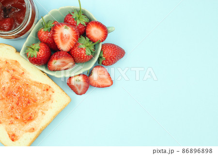 Top view of toast strawberries and jam on isolated pastel background with copy space. Top view of toast strawberries and jam on isolated pastel background with copy space. 86896898