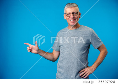 Happy mature man pointing finger to copy space 86897928