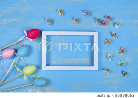 White frame, Easter eggs, flowers and rabbit ears 86898062