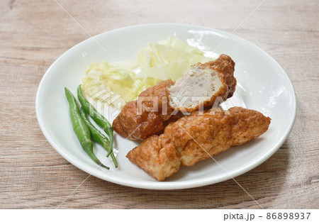 fried fermenting fish line eat with fresh cabbage and chili on plate 86898937