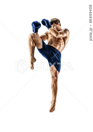 Full length of male kickboxer in blue sportswear on white background. muscular athlete fighting 86899406