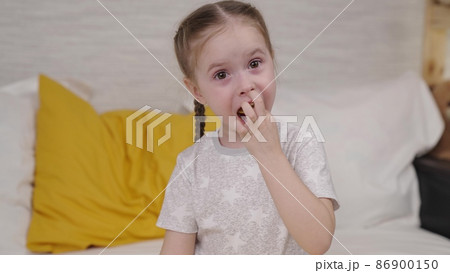 little girl eating potato chips while sitting on the bed, enjoying taste of crisp at home, useless food with spices, seasoned food snack small child, happiness in children's variety goodies vegetable little girl eating potato chips while sitting on the bed, enjoying taste of crisp at home, useless food with spices, seasoned food snack small child, happiness in children's variety goodies vegetable 86900150