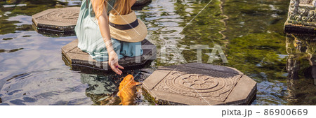 Young woman tourist in Taman Tirtagangga, Water palace, Water park, Bali Indonesia BANNER, LONG FORMAT 86900669