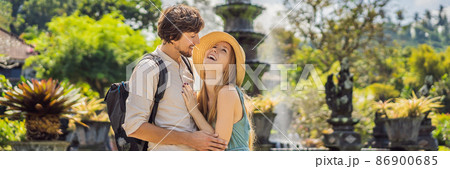 Happy loving couple in Taman Tirtagangga, Water palace, Water park, Bali Indonesia. Honeymoon in Bali BANNER, LONG FORMAT 86900685