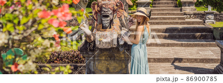 Young woman tourist in Taman Tirtagangga, Water palace, Water park, Bali Indonesia BANNER, LONG FORMAT Young woman tourist in Taman Tirtagangga, Water palace, Water park, Bali Indonesia BANNER, LONG FORMAT 86900785