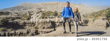 BANNER, LONG FORMAT Young couple man and woman visit the Bromo volcano at the Tengger Semeru National Park on the Java Island, Indonesia. They enjoy magnificent view on the Bromo or Gunung Bromo on BANNER, LONG FORMAT Young couple man and woman visit the Bromo volcano at the Tengger Semeru National Park on the Java Island, Indonesia. They enjoy magnificent view on the Bromo or Gunung Bromo on 86901798