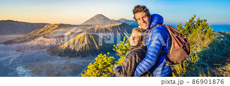 BANNER, LONG FORMAT Young couple man and woman meet the sunrise at the Bromo Tengger Semeru National Park on the Java Island, Indonesia. They enjoy magnificent view on the Bromo or Gunung Bromo on BANNER, LONG FORMAT Young couple man and woman meet the sunrise at the Bromo Tengger Semeru National Park on the Java Island, Indonesia. They enjoy magnificent view on the Bromo or Gunung Bromo on 86901876