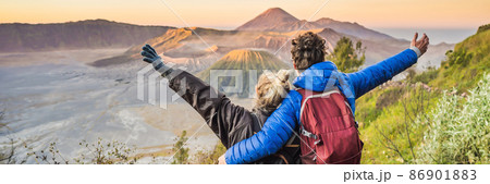 BANNER, LONG FORMAT Young couple man and woman meet the sunrise at the Bromo Tengger Semeru National Park on the Java Island, Indonesia. They enjoy magnificent view on the Bromo or Gunung Bromo on BANNER, LONG FORMAT Young couple man and woman meet the sunrise at the Bromo Tengger Semeru National Park on the Java Island, Indonesia. They enjoy magnificent view on the Bromo or Gunung Bromo on 86901883