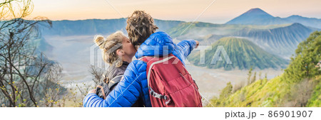 BANNER, LONG FORMAT Young couple man and woman meet the sunrise at the Bromo Tengger Semeru National Park on the Java Island, Indonesia. They enjoy magnificent view on the Bromo or Gunung Bromo on 86901907