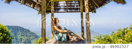 Young woman in traditional balinese gazebo. Bali island BANNER, LONG FORMAT 86902527