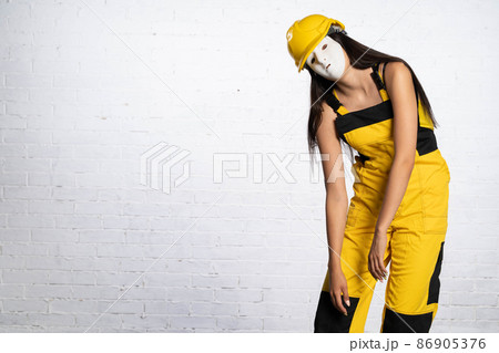 After hard work on the construction site, the hands drop by themselves and the fatigue makes itself felt. A very tired construction worker. 86905376