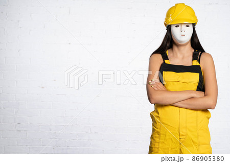 An anonymous construction worker is waiting for official orders to be issued so that she can start a new working day at the femoral square. An anonymous construction worker is waiting for official orders to be issued so that she can start a new working day at the femoral square. 86905380
