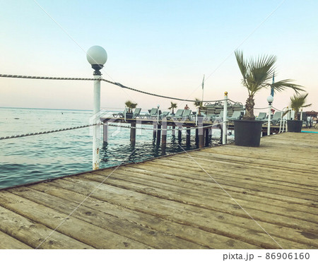 pontoon at sea. sea voyage in a warm country. a large and wide pontoon for tourists with lanterns for artificial light at night. walk on the water 86906160