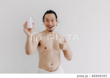 Man wear towel and presenting beauty product for men. Man wear towel and presenting beauty product for men. 86908365