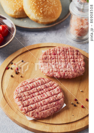 Raw veal mince Burger steak cutlets on wooden cutting board 86908508