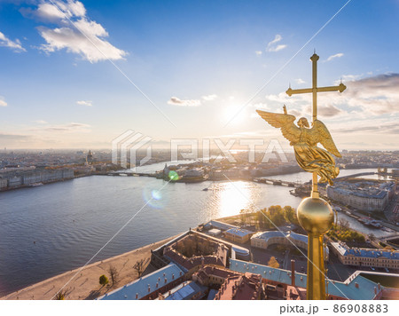Russia, St. Petersburg, Aerial landscape of Peter and Paul cathedral at sunset, walls of fortress, Golden autumn, panorama landscape, golden spire with cross and angel, drawbridges, river Neva 86908883