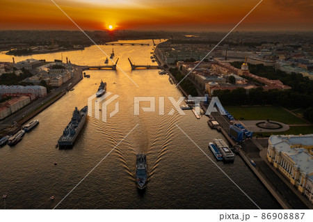 Aerial landscape with warships in the Neva River before the holiday of the Russian Navy at early morning, warships pass under a raised drawbridge, the latest cruisers among landmarks, Palace bridge Aerial landscape with warships in the Neva River before the holiday of the Russian Navy at early morning, warships pass under a raised drawbridge, the latest cruisers among landmarks, Palace bridge 86908887