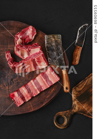 Raw fresh beef short ribs on chopping slab Raw fresh beef short ribs on chopping slab 86909555