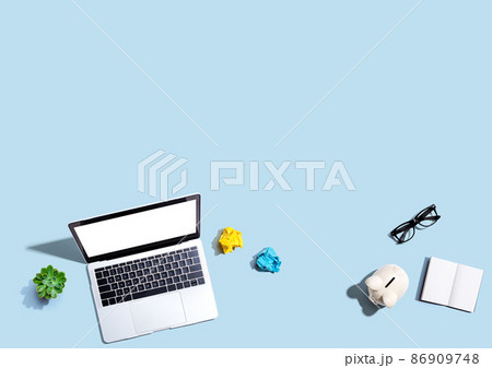 Laptop computer with a piggy bank and office objects Laptop computer with a piggy bank and office objects 86909748