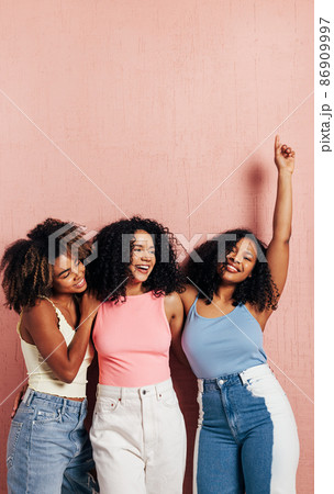 Portrait of three laughing females with curly hair. Happy women having fun together 86909997
