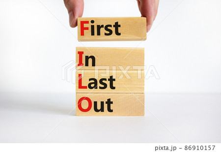 FILO first in last out symbol. Concept words FILO first in last out on wooden blocks. Beautiful white table white background. Businessman hand. Business and FILO first in last out concept. Copy space. FILO first in last out symbol. Concept words FILO first in last out on wooden blocks. Beautiful white table white background. Businessman hand. Business and FILO first in last out concept. Copy space. 86910157